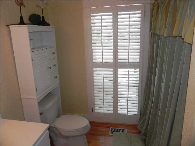 630 Blue Mountain Beach Road Santa Rosa Beach, FL 32459 - Photo 19 of 26 a bathroom with a toilet a sink and a window