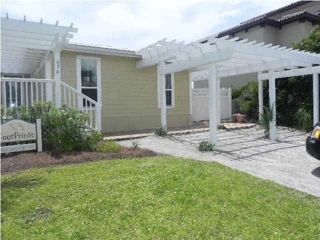 630 Blue Mountain Beach Road Santa Rosa Beach, FL 32459 - Photo 25 of 26 a backyard of a house with yard and outdoor seating