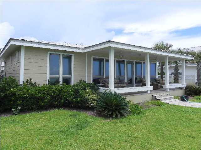 630 Blue Mountain Beach Road Santa Rosa Beach, FL 32459 - Photo 6 of 26 a front view of a house with porch and garden