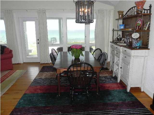 630 Blue Mountain Beach Road Santa Rosa Beach, FL 32459 - Photo 10 of 26 a view of a dining room with furniture window and wooden floor