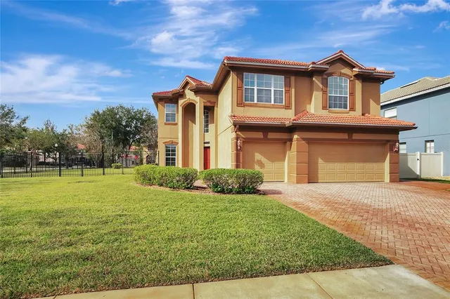 a front view of a house with yard and green space