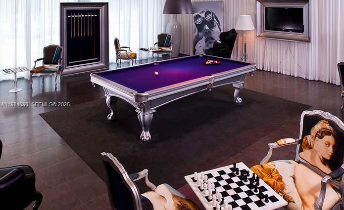 475 Brickell Avenue, Unit 910 Miami, FL 33131 - Photo 12 of 13 a room with furniture pool table and flat screen tv