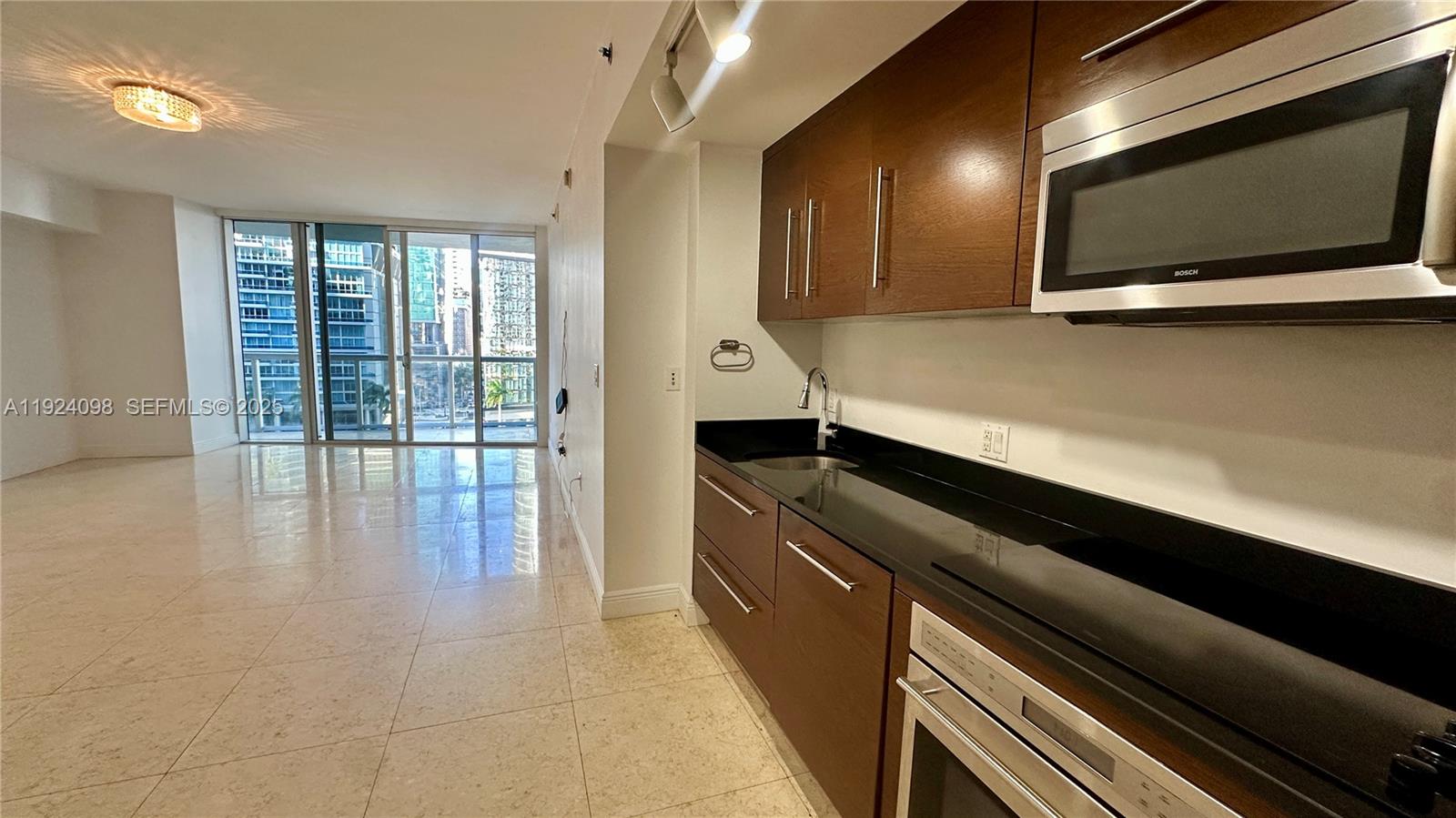 475 Brickell Avenue, Unit 910 Miami, FL 33131 - Photo 2 of 13 a kitchen with stainless steel appliances a large counter top