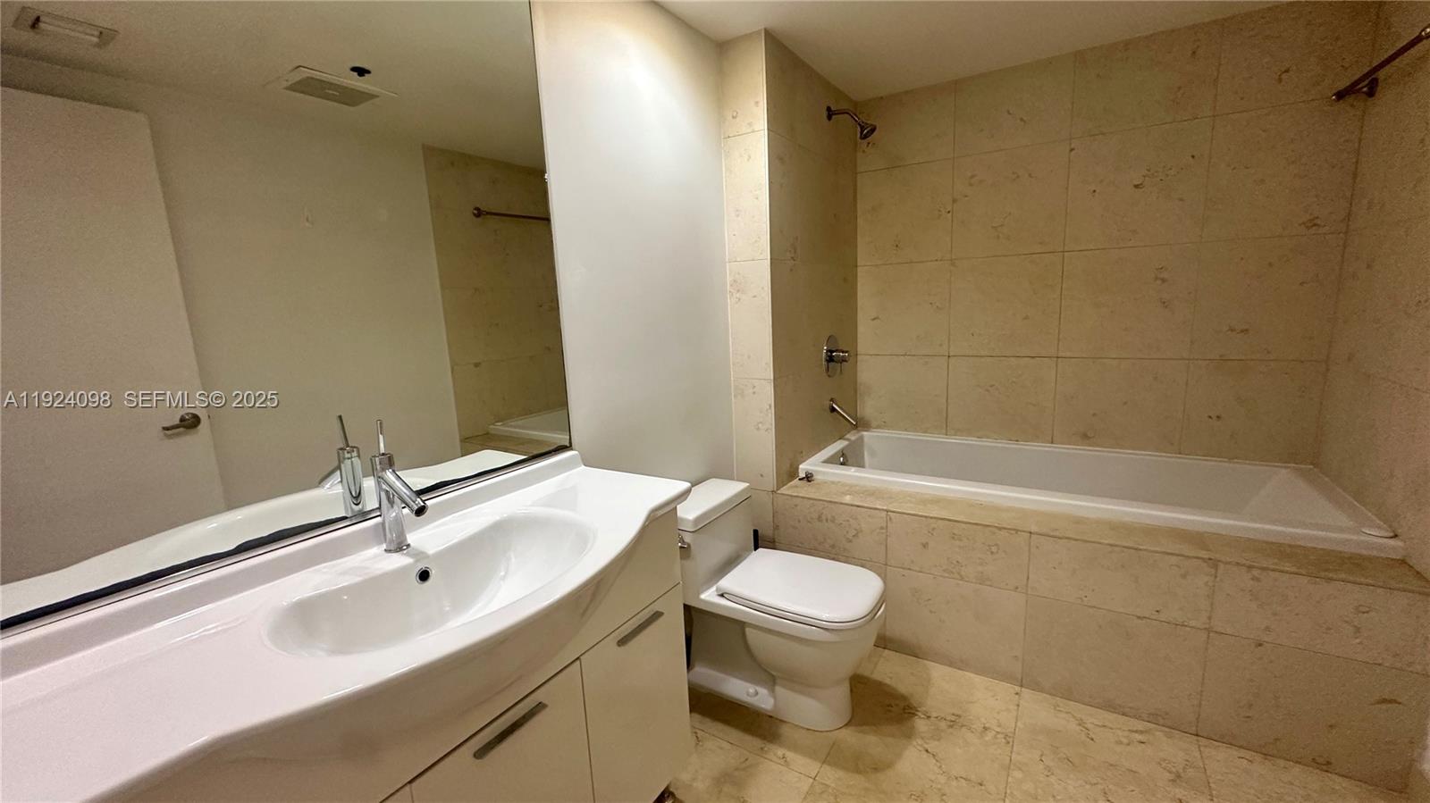 475 Brickell Avenue, Unit 910 Miami, FL 33131 - Photo 5 of 13 a bathroom with a sink toilet and shower