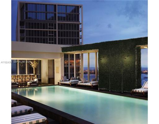475 Brickell Avenue, Unit 910 Miami, FL 33131 - Photo 10 of 13 a view of a swimming pool with outdoor seating