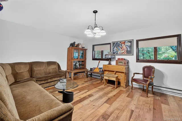 a living room with furniture and a chandelier
