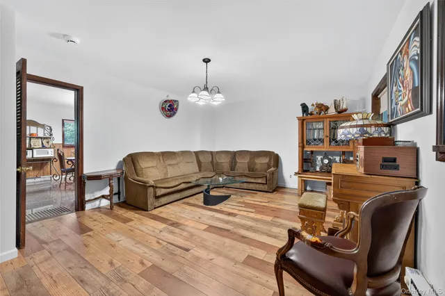 a living room with furniture and a chandelier