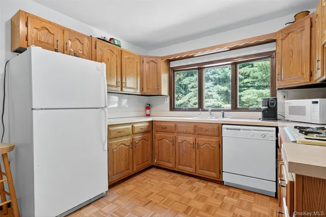 a kitchen with stainless steel appliances a refrigerator sink and cabinets