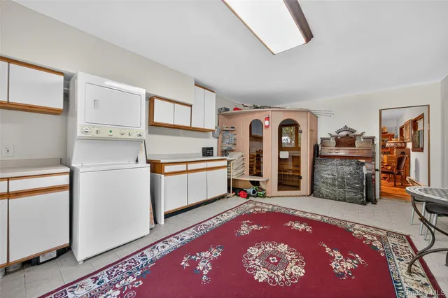 a living room with stainless steel appliances furniture or kitchen view and a window