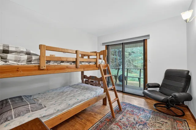 a bedroom with furniture and a large window