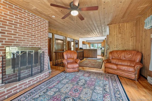 a living room with furniture a lamp and a rug