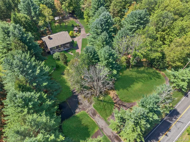 an aerial view of a house with a yard