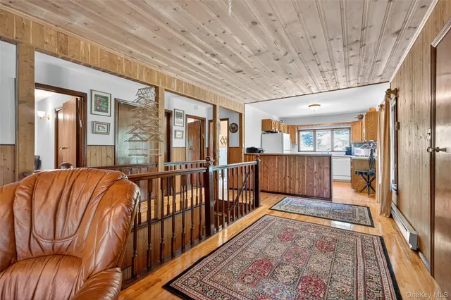 a view of a bedroom with wooden floor and stairs