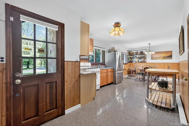 a living room with furniture a fireplace and a window