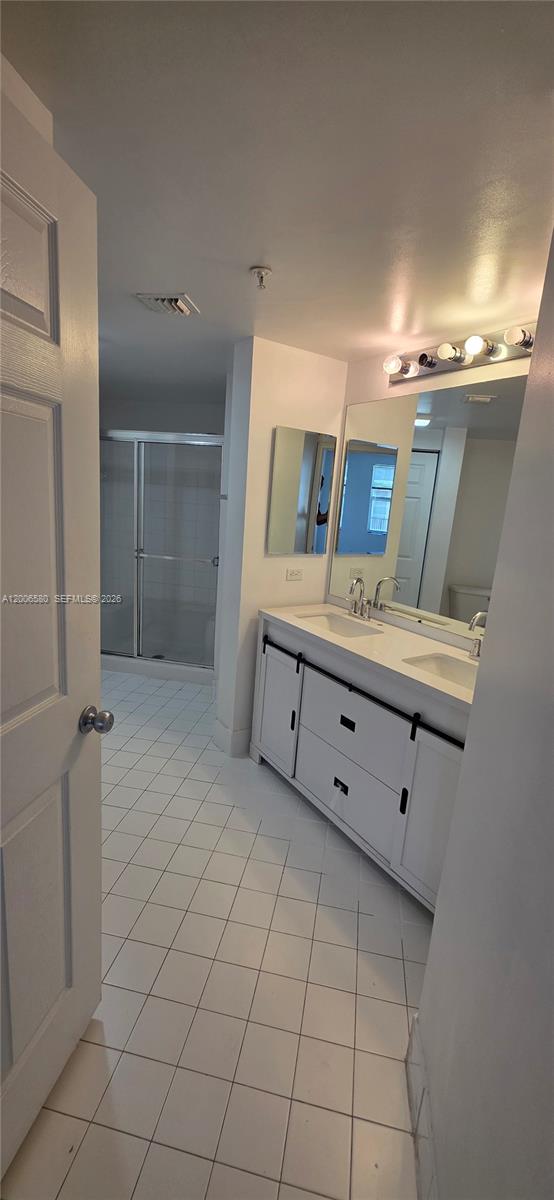 17150 North Bay Road, Unit 2602 Sunny Isles Beach, FL 33160 - Photo 23 of 27 a bathroom with a sink mirror and vanity