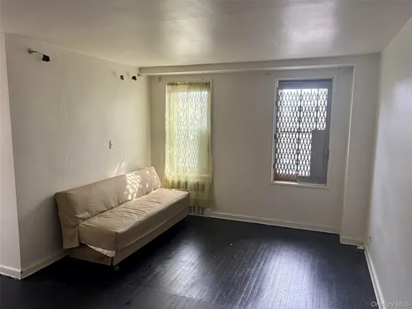 a bed sitting in a bedroom next to a window