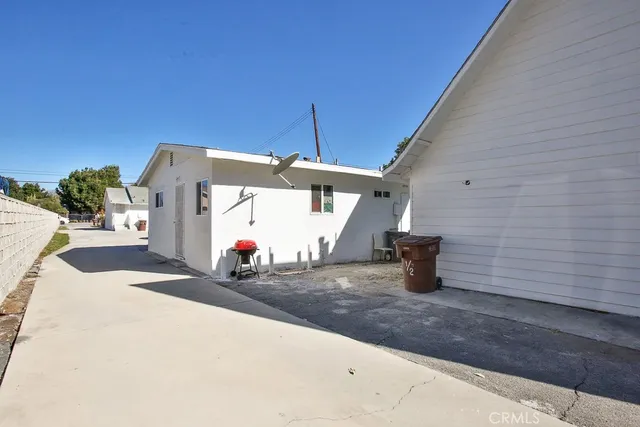 a sign board with buildings in the background