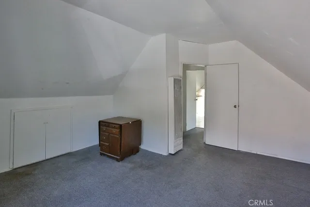 an empty room with closet and cabinet