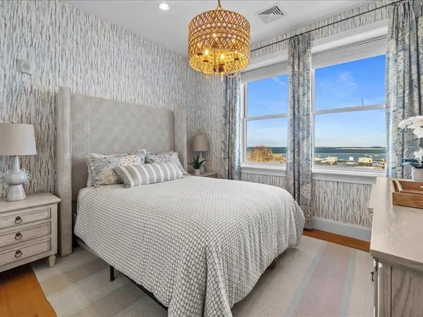 a bedroom with a bed and a chandelier