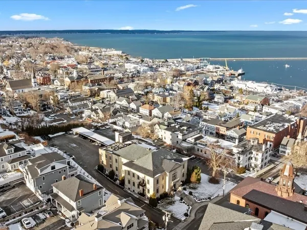 an aerial view of a building with parking