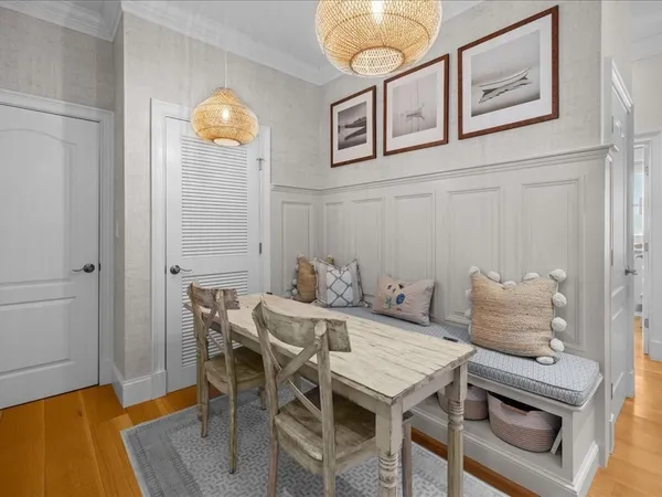 a view of a dining room with furniture and a chandelier