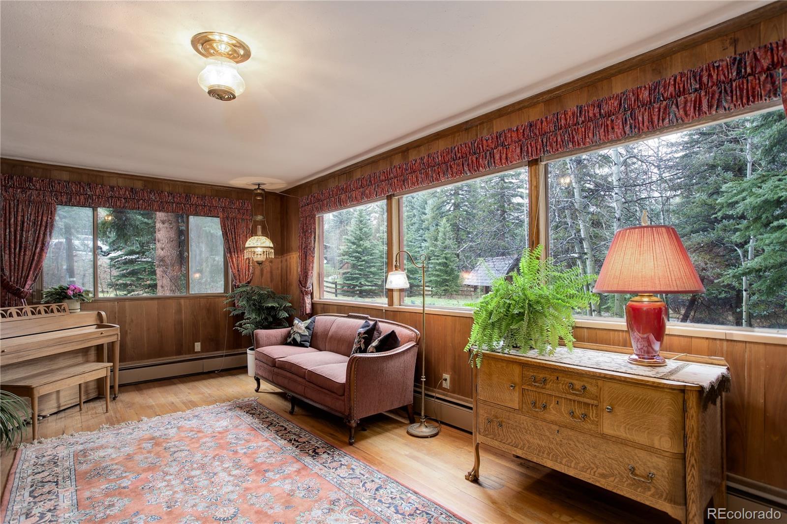 1730 Upper Bear Creek Road Evergreen, CO 80439 - Photo 15 of 40 a living room with furniture and a large window
