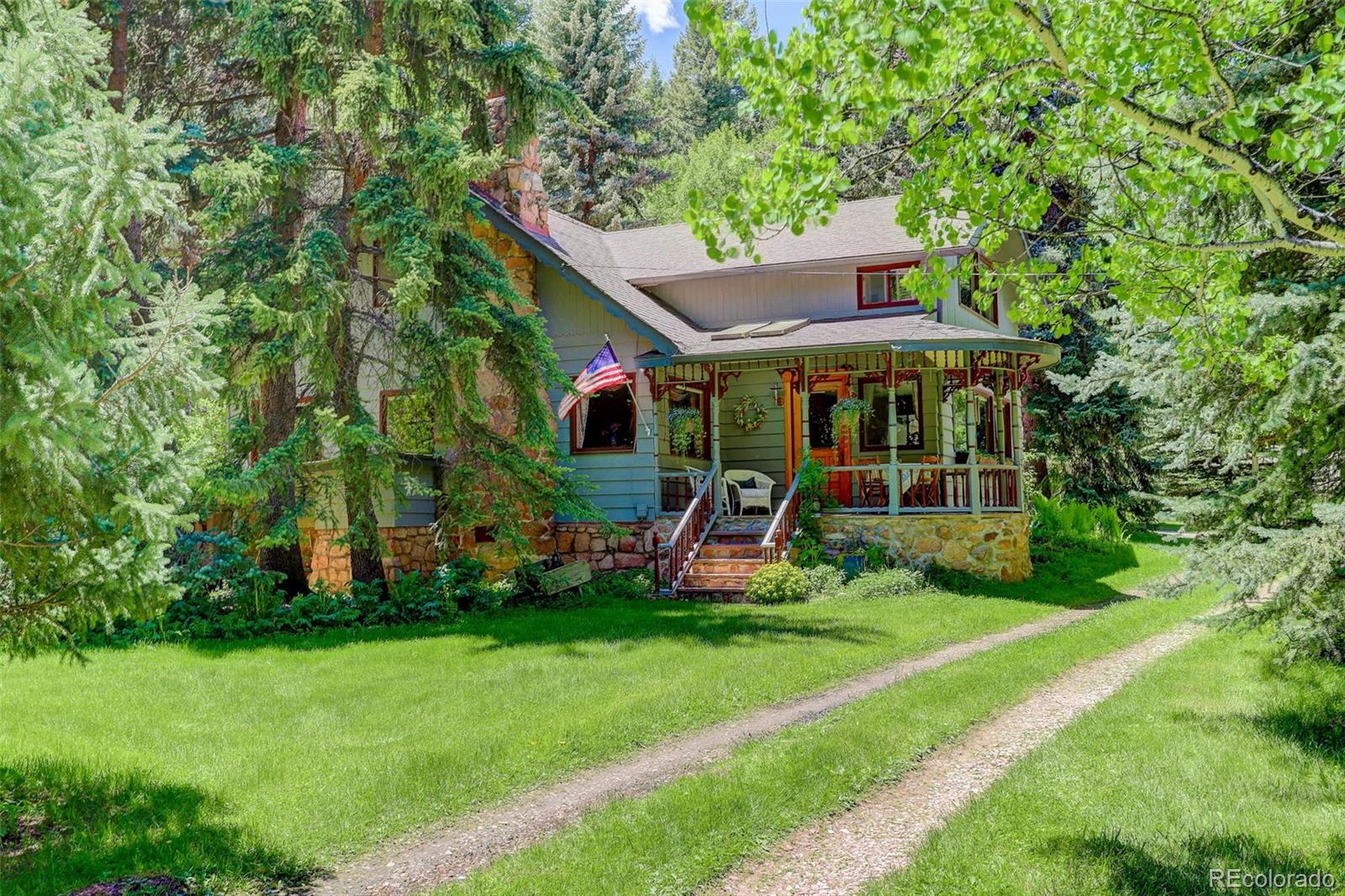 1730 Upper Bear Creek Road Evergreen, CO 80439 - Photo 2 of 40 a view of a house with backyard sitting area and garden