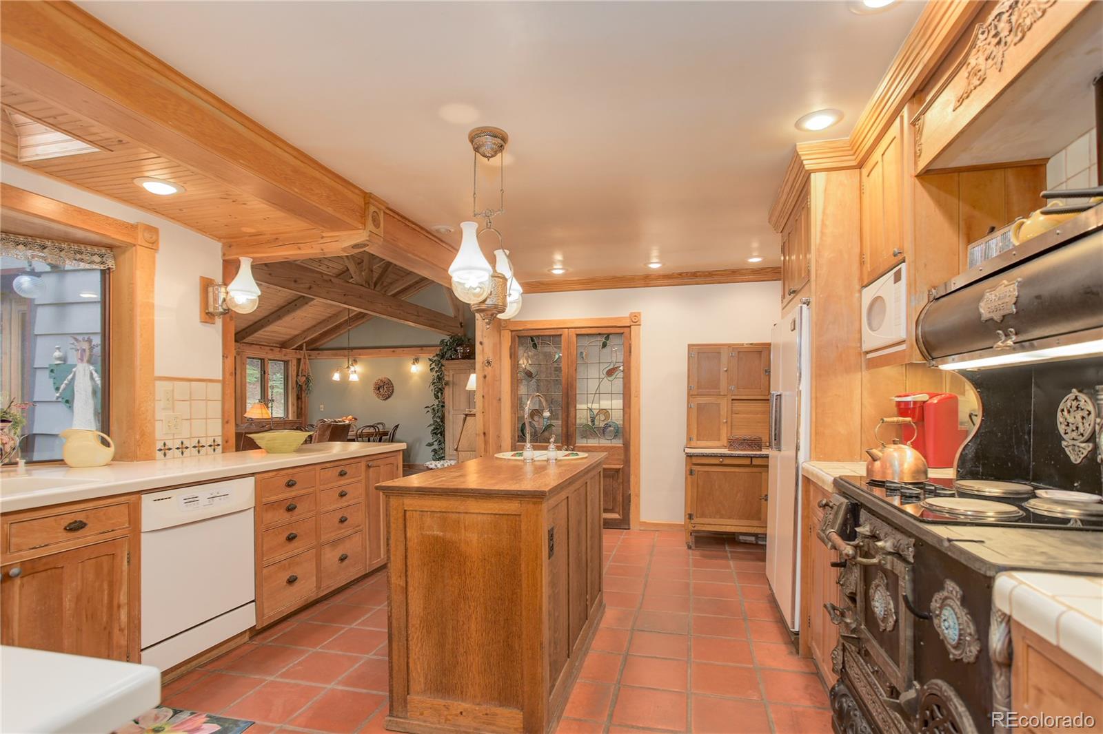1730 Upper Bear Creek Road Evergreen, CO 80439 - Photo 21 of 40 a kitchen with lot of cabinets and refrigerator