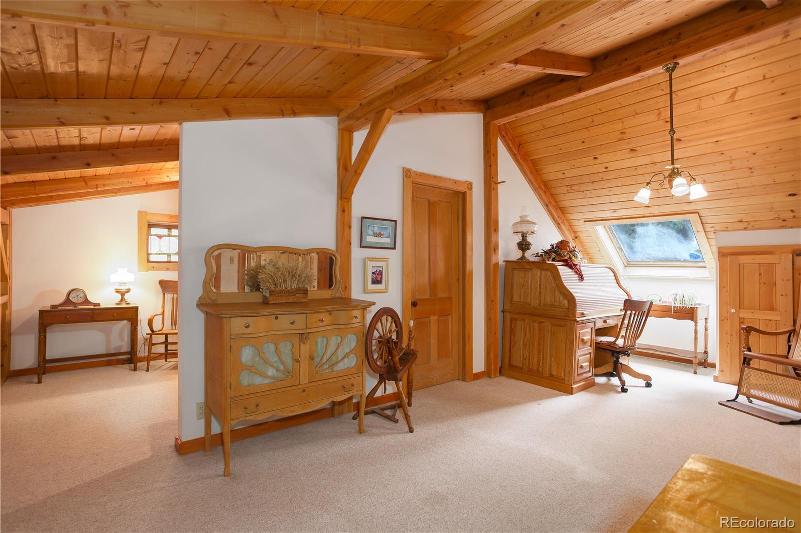 1730 Upper Bear Creek Road Evergreen, CO 80439 - Photo 28 of 40 a bedroom with furniture and a window