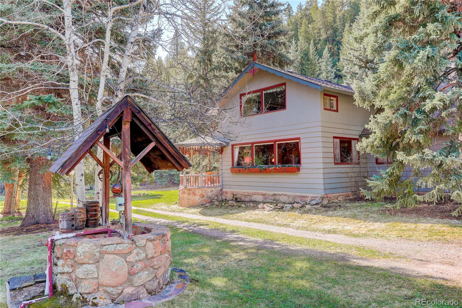 1730 Upper Bear Creek Road Evergreen, CO 80439 - Photo 34 of 40 a view of a house with backyard and sitting area