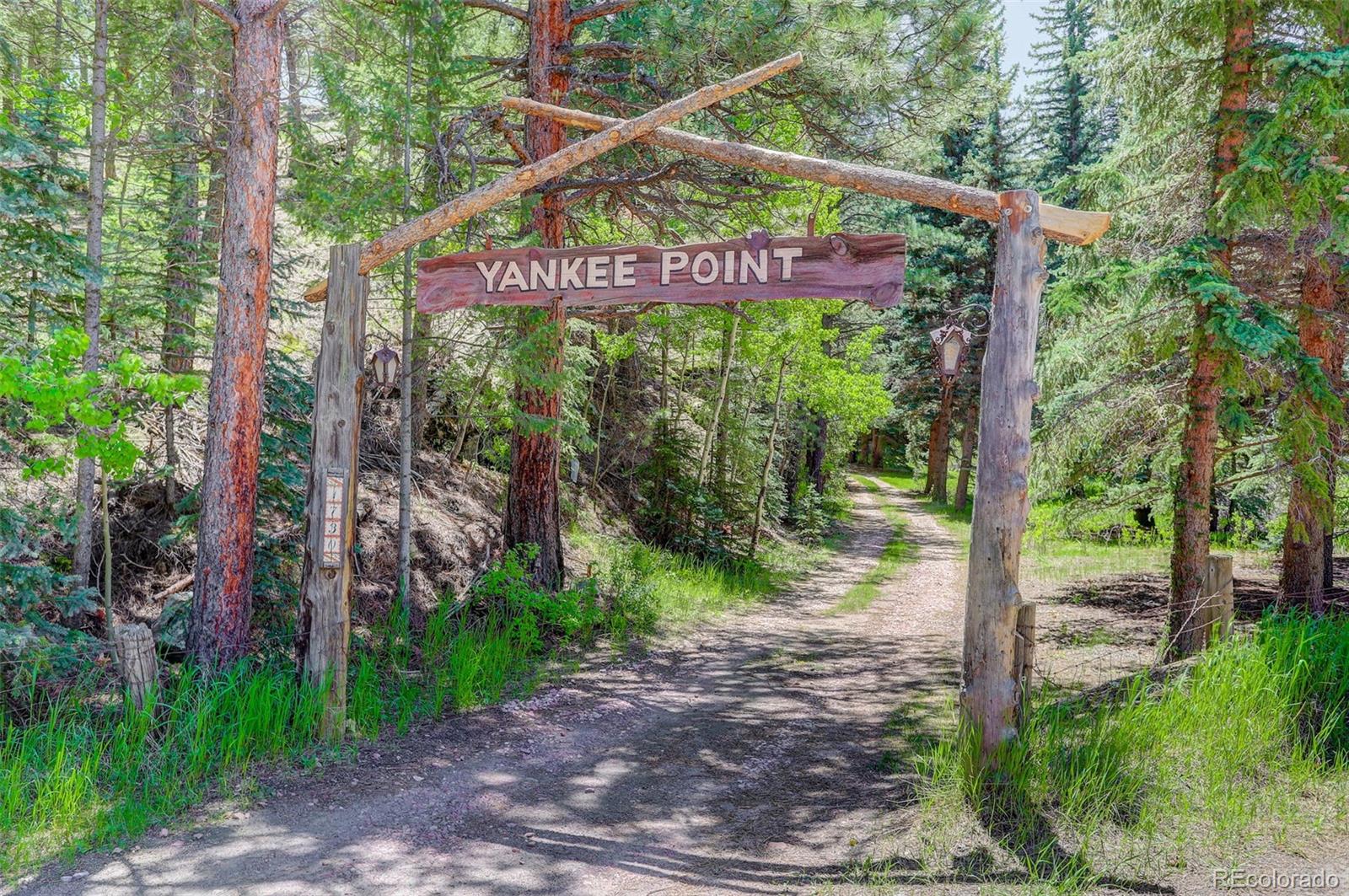 1730 Upper Bear Creek Road Evergreen, CO 80439 - Photo 4 of 40 a sign that is on the side of a road