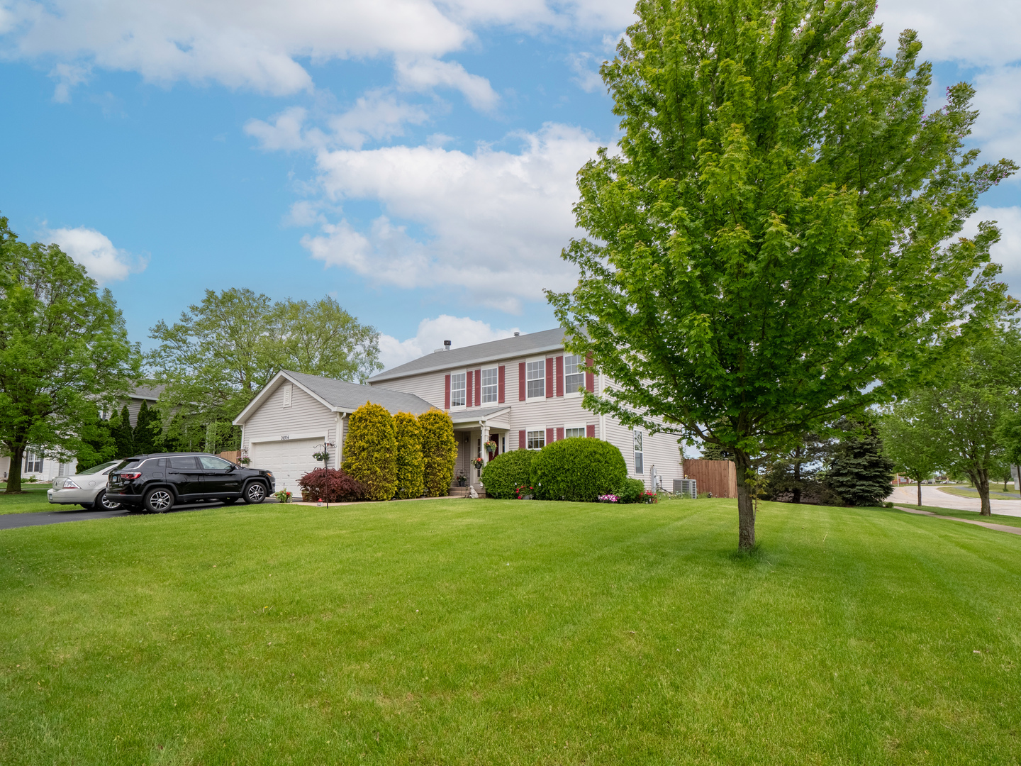 26956 West Hemlock Road Channahon, IL 60410 - Photo 1 of 17 a view of a white house that has a tree in front of it