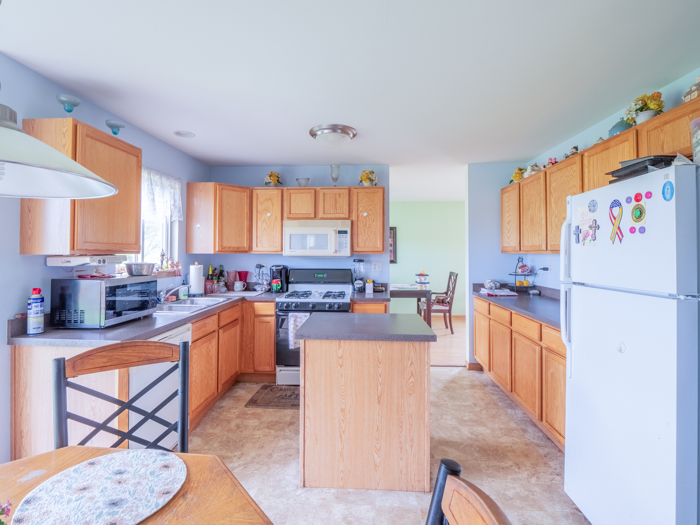 26956 West Hemlock Road Channahon, IL 60410 - Photo 7 of 17 a kitchen with stainless steel appliances a stove a sink a refrigerator and cabinets