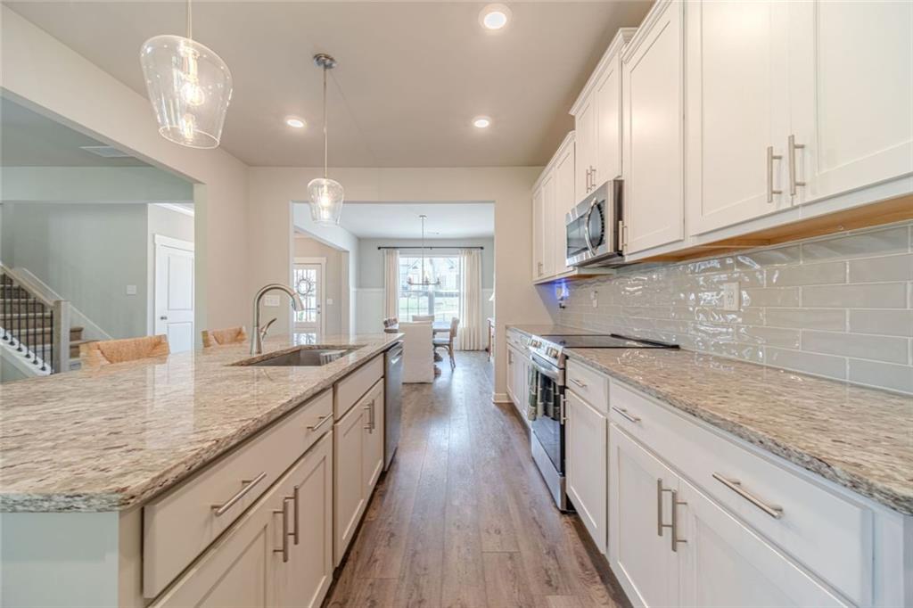 4070 Links Boulevard Jefferson, GA 30549 - Photo 12 of 46 a kitchen with stainless steel appliances granite countertop a sink and stove