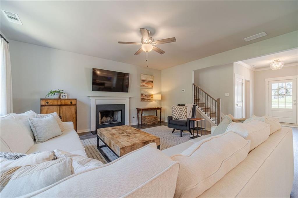 4070 Links Boulevard Jefferson, GA 30549 - Photo 15 of 46 a living room with furniture a flat screen tv and a fireplace
