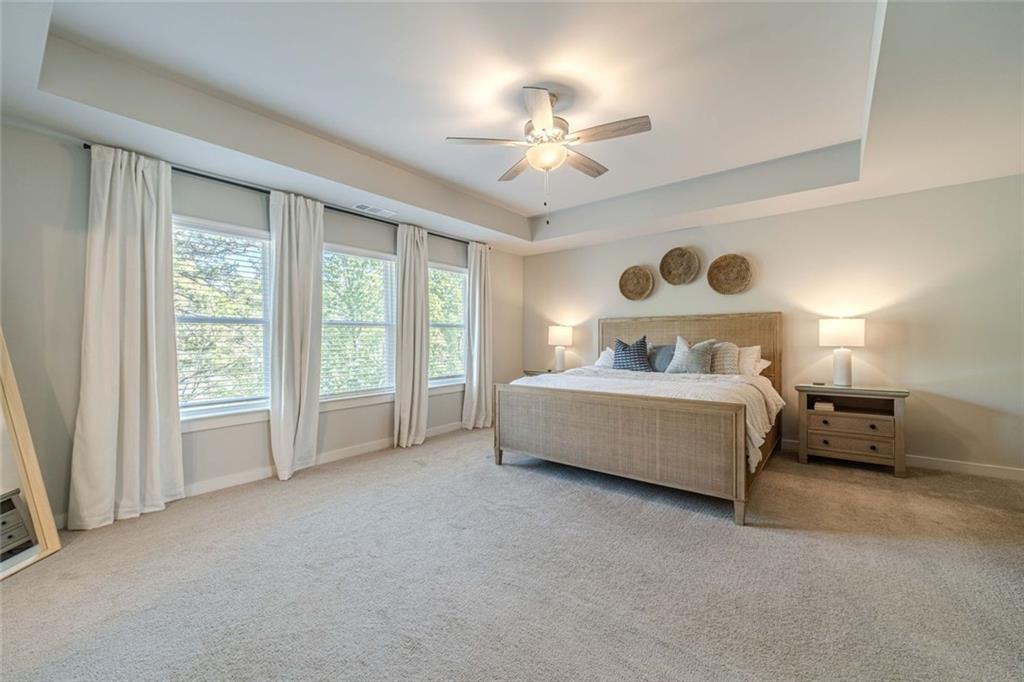 4070 Links Boulevard Jefferson, GA 30549 - Photo 25 of 46 a bedroom with a bed and a chandelier