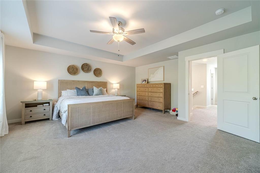4070 Links Boulevard Jefferson, GA 30549 - Photo 26 of 46 a bedroom with a bed and a chandelier