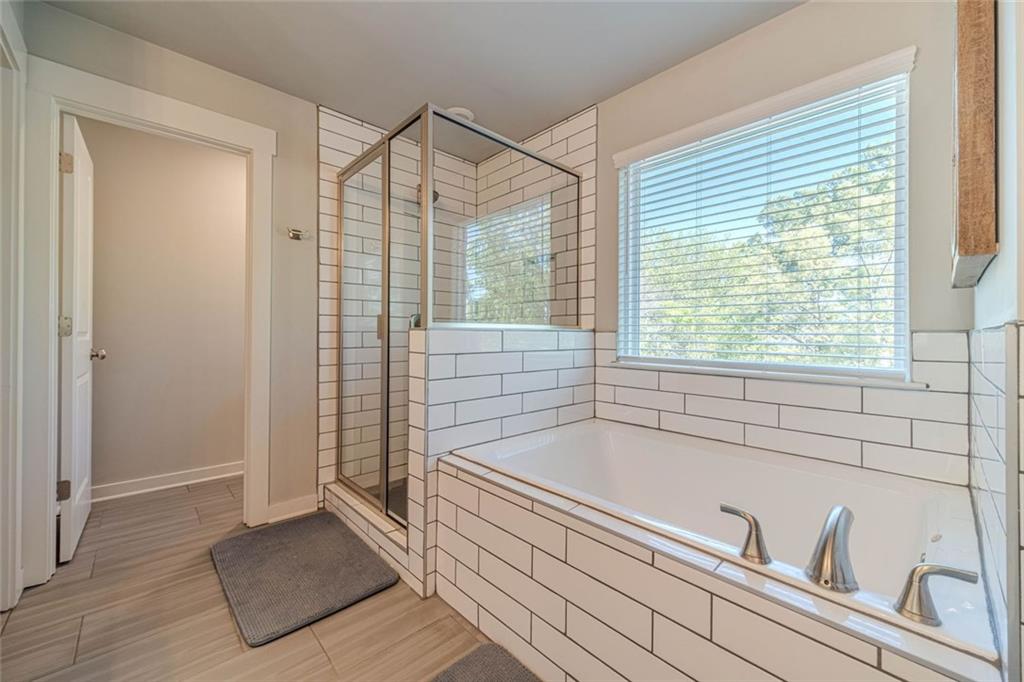 4070 Links Boulevard Jefferson, GA 30549 - Photo 30 of 46 a bathroom with a bathtub and a shower
