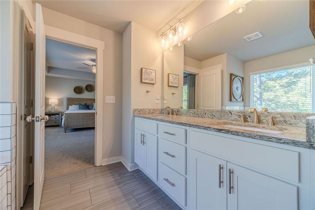 4070 Links Boulevard Jefferson, GA 30549 - Photo 31 of 46 a en suite bathroom with a granite countertop sink and a mirror