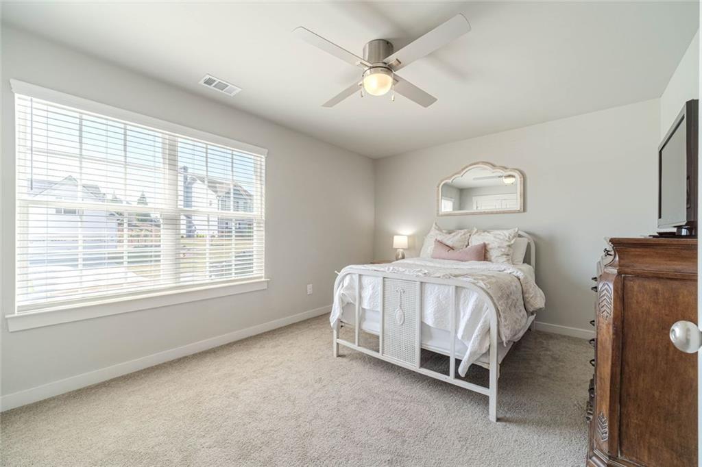 4070 Links Boulevard Jefferson, GA 30549 - Photo 33 of 46 a bedroom with a bed and a ceiling fan