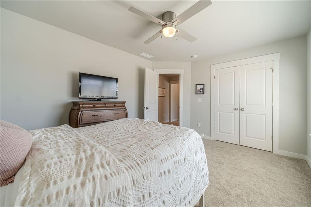 4070 Links Boulevard Jefferson, GA 30549 - Photo 34 of 46 a spacious bedroom with a bed and a flat screen tv
