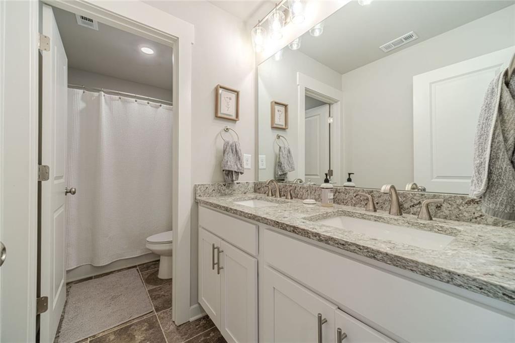 4070 Links Boulevard Jefferson, GA 30549 - Photo 35 of 46 a bathroom with a granite countertop sink toilet and shower