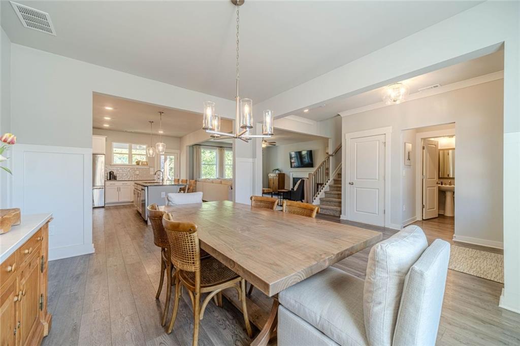 4070 Links Boulevard Jefferson, GA 30549 - Photo 9 of 46 a dining room with furniture a chandelier and wooden floor