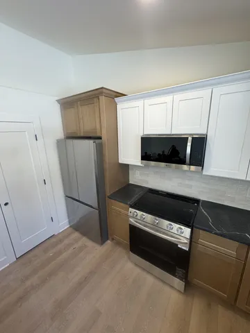 a kitchen with a refrigerator and a stove