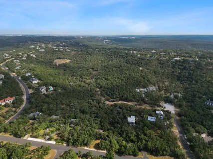 an aerial view of house with yard and mountain view in back