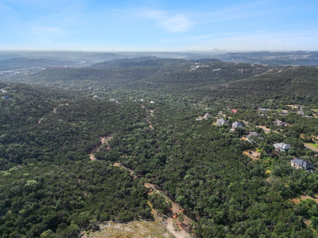 6002 Lost Trail Cove Austin, TX 78730 - Photo 17 of 28 a view of a city with lush green forest