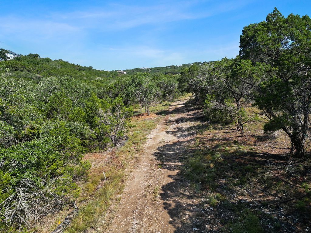 6002 Lost Trail Cove Austin, TX 78730 - Photo 27 of 28 a view of a field with a tree in the background