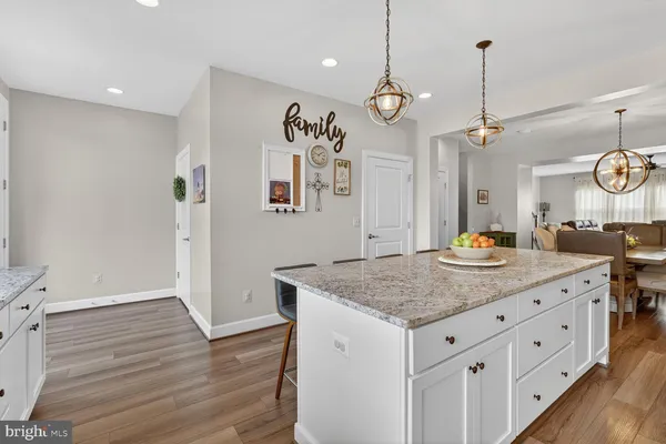 a kitchen with a counter space cabinets and wooden floor