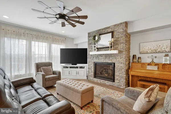 a living room with furniture a fireplace and a flat screen tv
