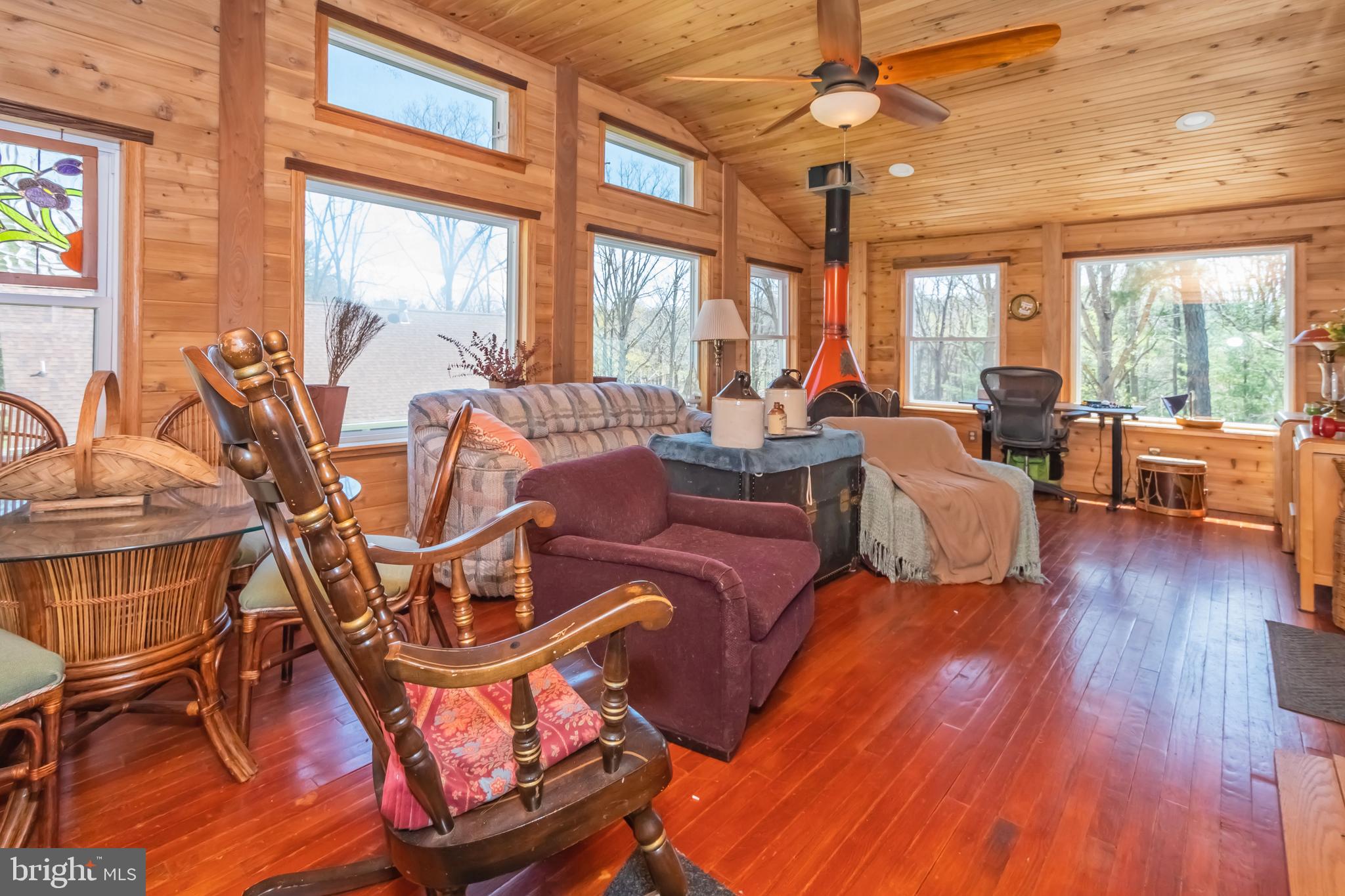 827 Penn Point Road Oakland, MD 21550 - Photo 59 of 64 a living room with furniture a wooden floor and a large window